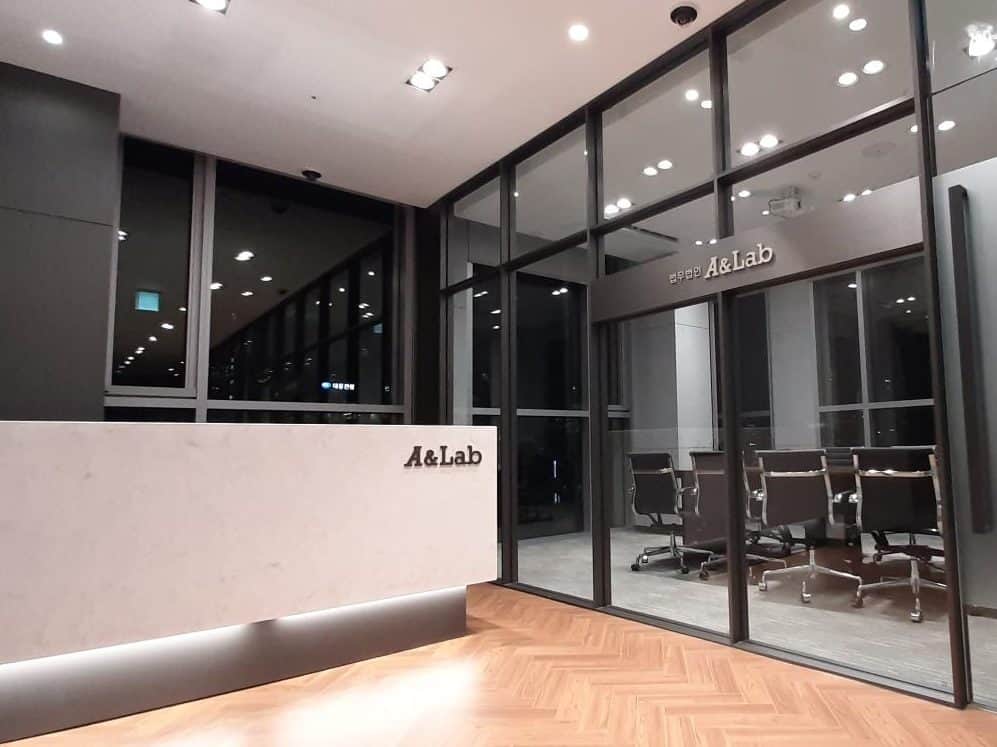 사무실에서 협약서를 펼쳐 든 두 사람